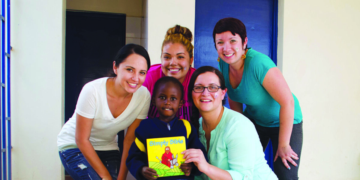 Jackie, Rosa, Christy and Maria with the recipient of a children’s story book Bible. Christy Mulberger and Jane McGrath.