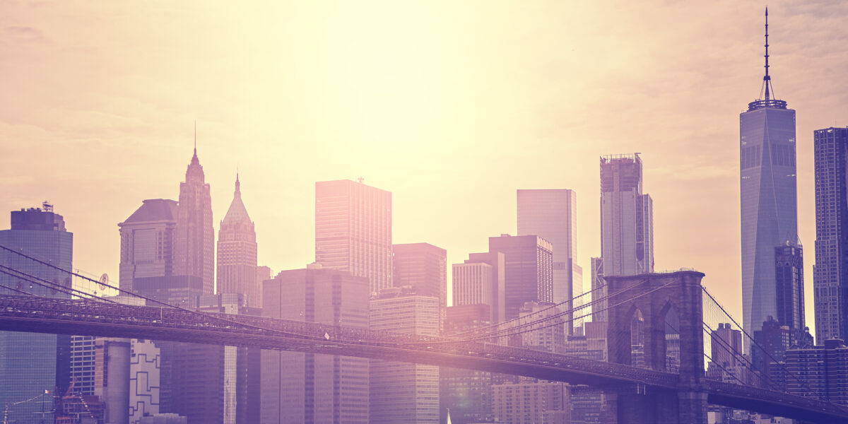 Vintage toned sunset over Manhattan and Brooklyn Bridge, NYC.