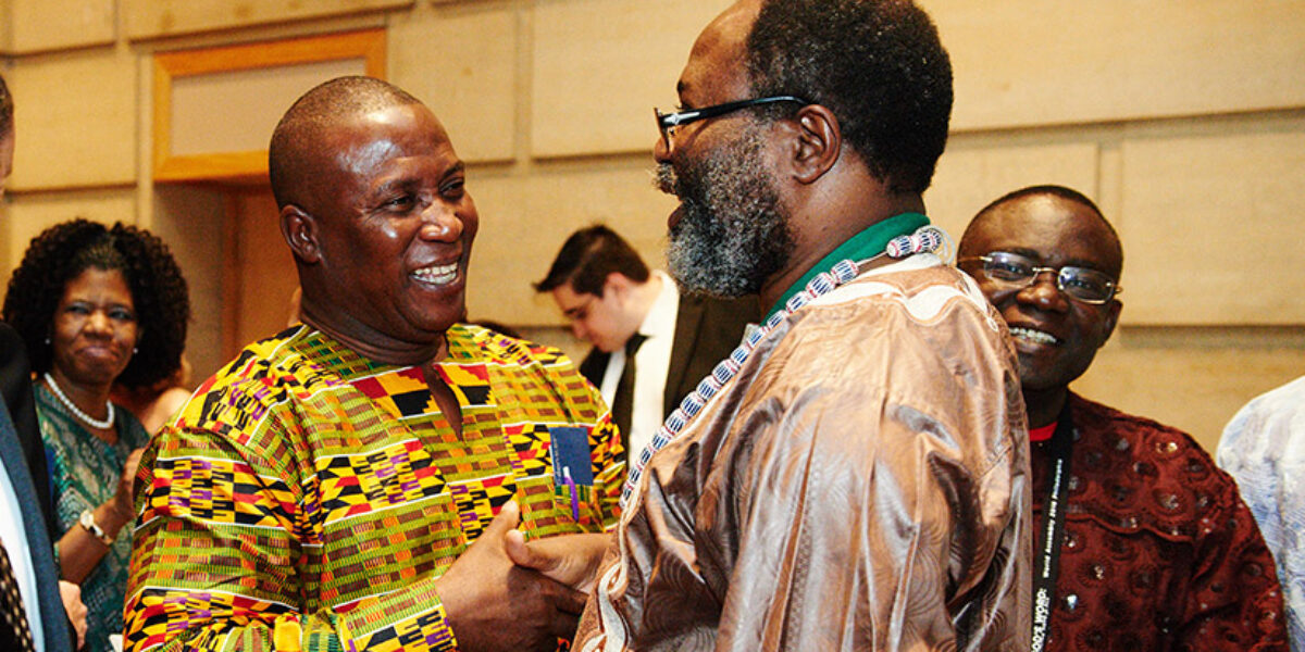 General Secretary of Bible Society of Ghana Erasmus Odonkor (left) greets Board Chair of Bible Society of Cameroon Jean Libom li Likeng (right). Photo Credit: Cinema Cake.