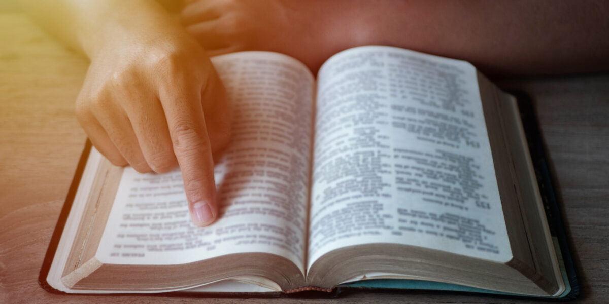 Close up of a man reading the Bible.